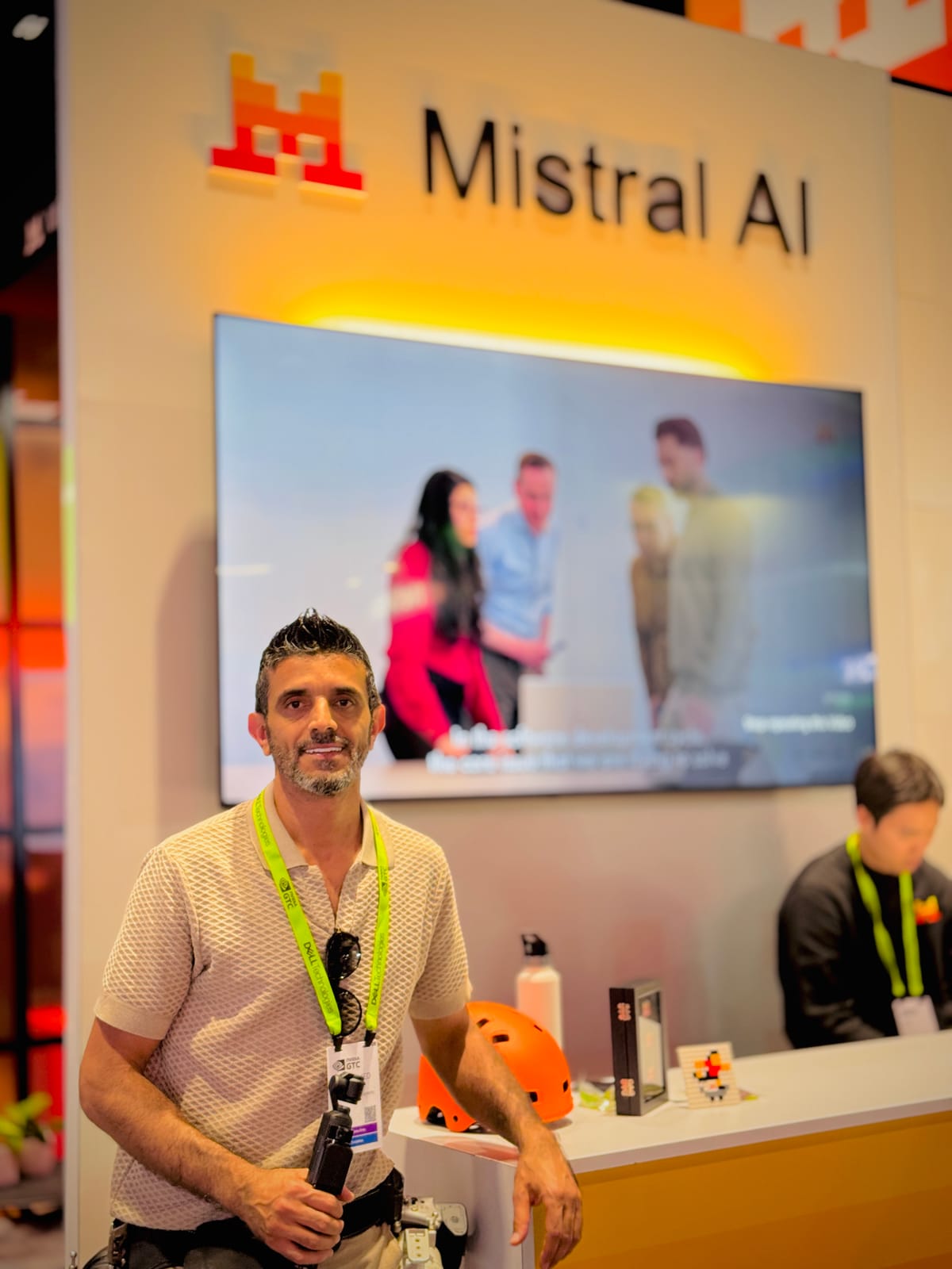 Simo Ahmadi working at the Mistral AI booth during a corporate technology event