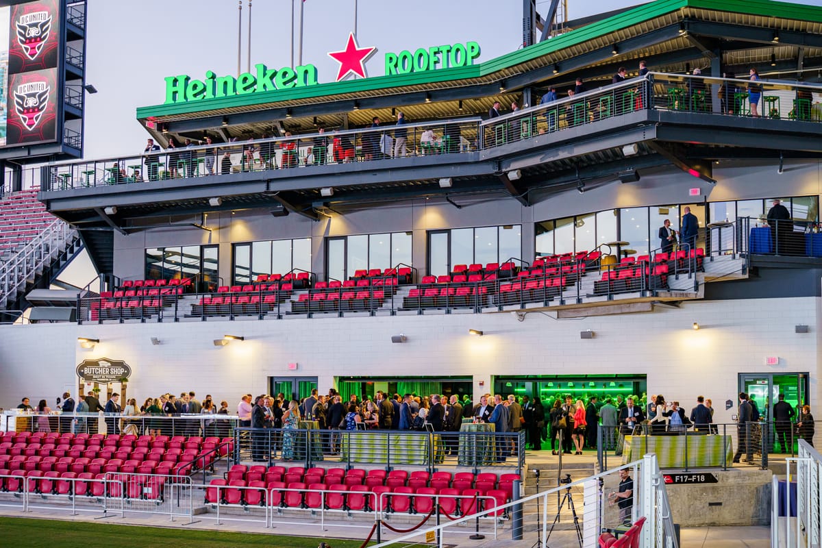 Corporate guests gathering inside a D.C. United stadium hospitality setting