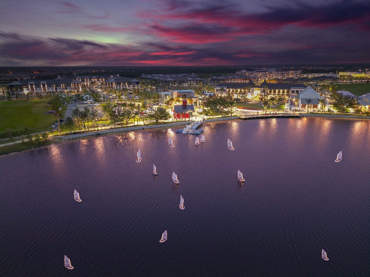 Aerial view of Wellen Park at dusk with sailboats crossing the lake