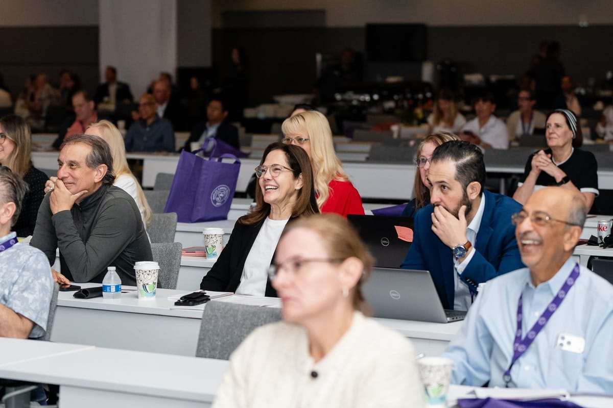 Medical professionals engaged during a cardiovascular summit presentation