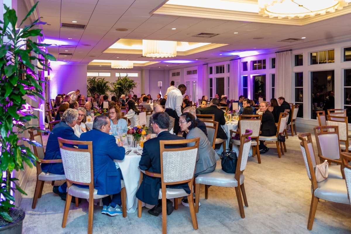 Guests dining together in the full Naples Cardiovascular Summit evening reception room